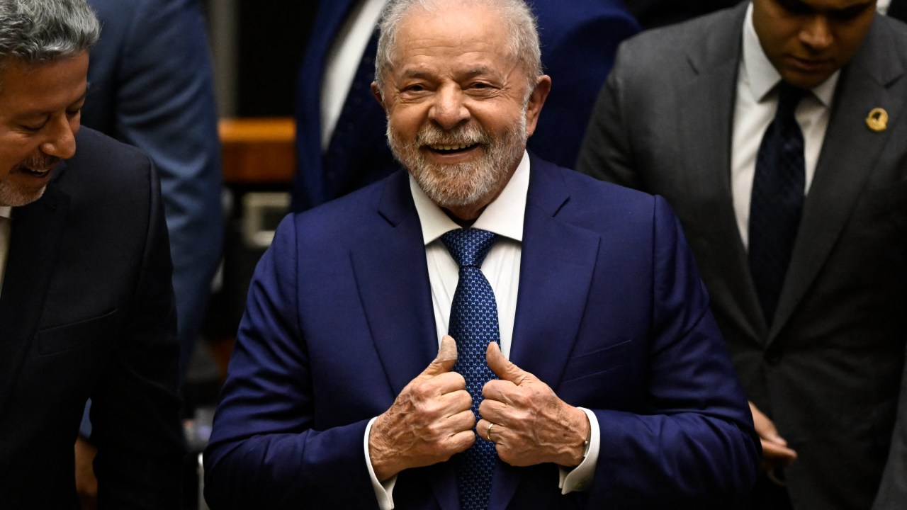 Brazil's new President Luiz Inacio Lula da Silva gives his thumbs up after swearing in during his inauguration ceremony at the National Congress, in Brasilia, on January 1, 2023. - Lula da Silva, a 77-year-old leftist who already served as president of Brazil from 2003 to 2010, takes office for the third time with a grand inauguration in Brasilia. (Photo by MAURO PIMENTEL / AFP)
