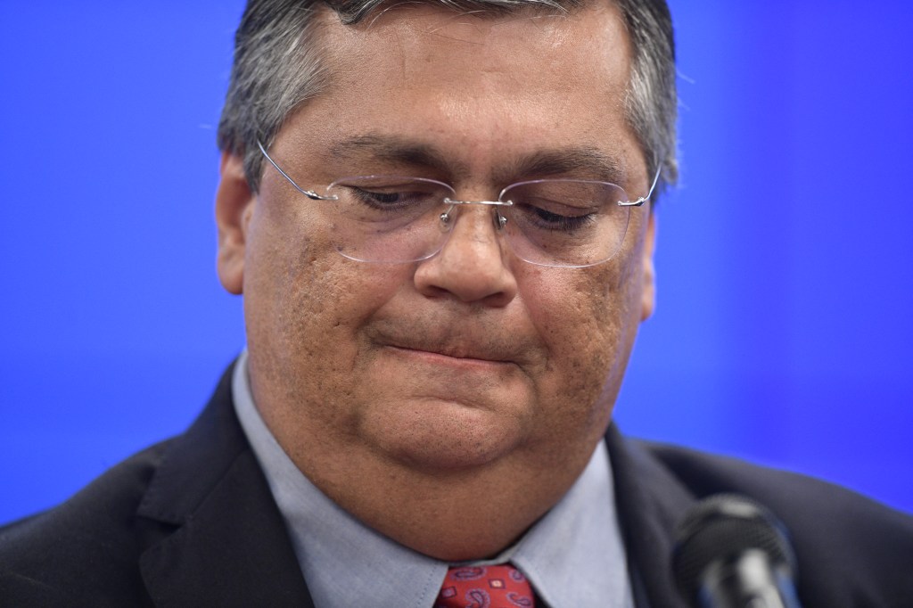 Brazilian Justice and Public Security Minister Flavio Dino gestures during a press conferente at the Justice Palace in Brasilia on January 9, 2023, a day after supporters of Brazil's far-right ex-president Jair Bolsonaro invaded the Congress, presidential palace and Supreme Court. - Brazilian security forces locked down the area around Congress, the presidential palace and the Supreme Court Monday, a day after supporters of ex-president Jair Bolsonaro stormed the seat of power in riots that triggered an international outcry. Hardline Bolsonaro supporters have been protesting outside army bases calling for a military intervention to stop Lula from taking power since his election win. (Photo by CARL DE SOUZA / AFP)