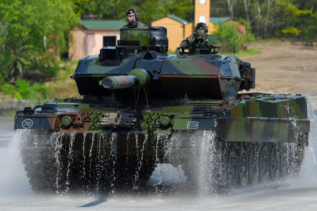 (FILES) This file photo taken on May 20, 2019 shows soldiers on a Leopard 2 A7 main battle tank of the German armed forces Bundeswehr driving during an educational practice of the "Very High Readiness Joint Task Force" (VJTF) as part of the NATO tank unit at the military training area in Munster, northern Germany. - Germany on January 25, 2023 approved the delivery of Leopard 2 tanks to Ukraine, after weeks of pressure from Kyiv and many allies. Berlin will provide a company of 14 Leopard 2 A6 tanks from the Bundeswehr stocks and is also granting approval for other European countries to send tanks from their own stocks to Ukraine, a government spokesman said in a statement. (Photo by PATRIK STOLLARZ / AFP)