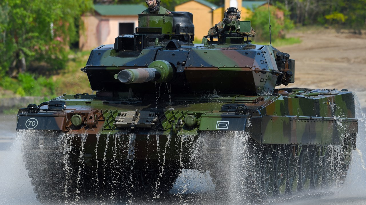 (FILES) This file photo taken on May 20, 2019 shows soldiers on a Leopard 2 A7 main battle tank of the German armed forces Bundeswehr driving during an educational practice of the "Very High Readiness Joint Task Force" (VJTF) as part of the NATO tank unit at the military training area in Munster, northern Germany. - Germany on January 25, 2023 approved the delivery of Leopard 2 tanks to Ukraine, after weeks of pressure from Kyiv and many allies. Berlin will provide a company of 14 Leopard 2 A6 tanks from the Bundeswehr stocks and is also granting approval for other European countries to send tanks from their own stocks to Ukraine, a government spokesman said in a statement. (Photo by PATRIK STOLLARZ / AFP)