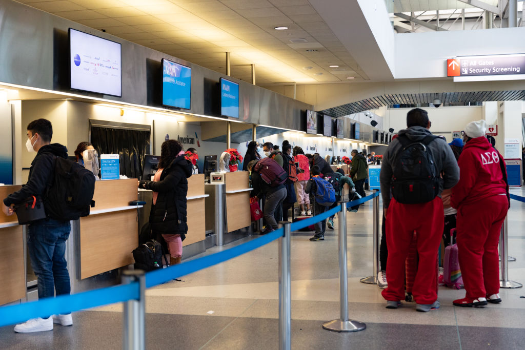 Travelers at the American Airlines check-in counter at Philadelphia International Airport (PHL) in Philadelphia, Pennsylvania, US, on Friday, Dec. 23, 2022. An estimated 112.7 million people will travel 50 miles or more from Dec. 23 to Jan. 2, up by 3.6 million from last year and getting close to pre-pandemic levels, according to AAA, a provider of travel insurance. Hannah Beier/Bloomberg via Getty Images
