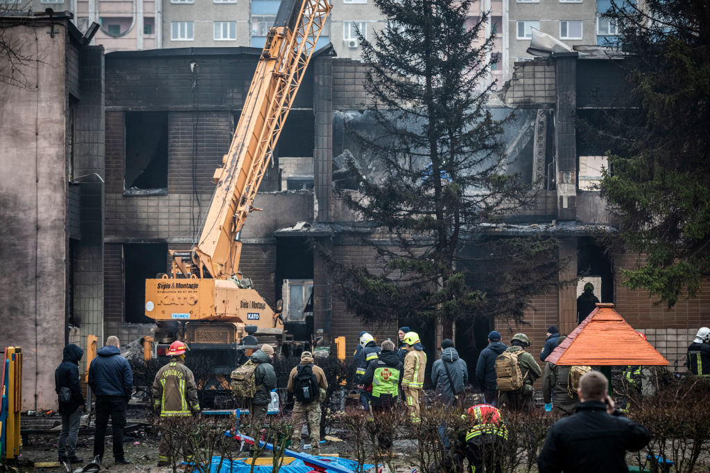 BROVARY, UKRAINE - JANUARY 18: Firemen and emergency service workers respond at the site of a helicopter crash on January 18, 2023 in Brovary, Ukraine. Eighteen people have been killed, including Ukraine's interior affairs minister Denys Monastyrsky along with eight other helicopter passengers, after they crashed near a nursery in a Kyiv suburb. (Photo by Ed Ram/Getty Images)