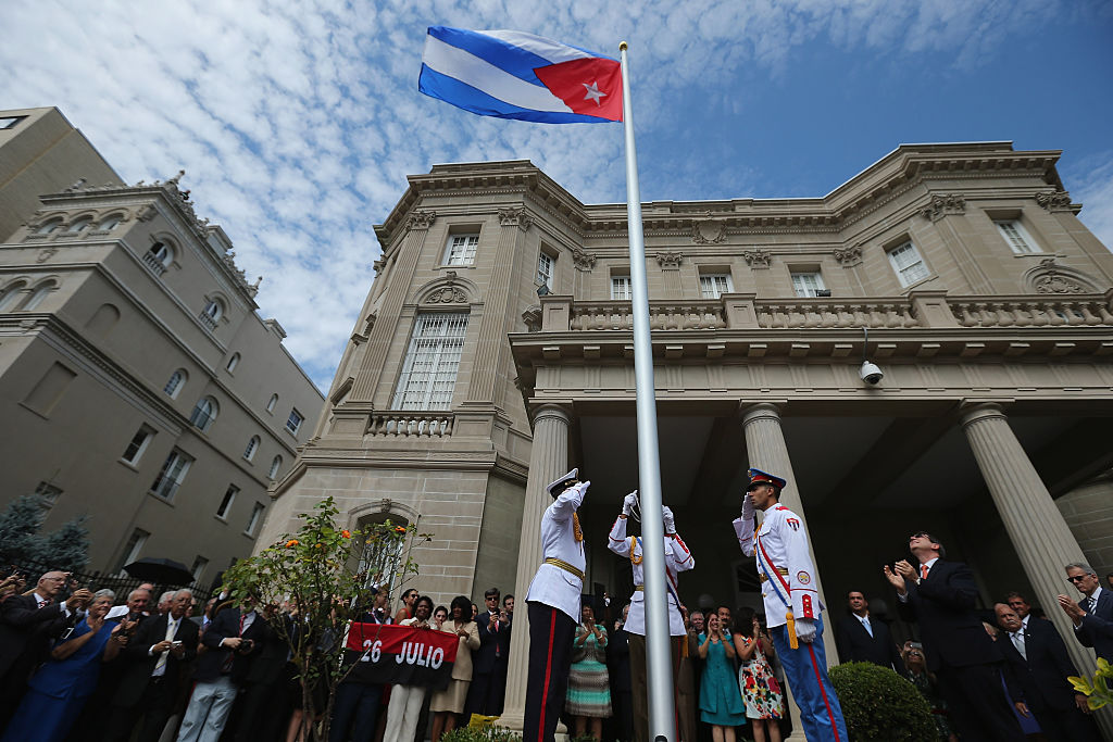 WASHINGTON, DC - JULY 20: Cuban Foreign Minister Bruno Rodriguez (2nd R) applauds as the Cuban flag is raised in front of the country's embassy for the first time in 54 years July 20, 2015 in Washington, DC. The embassy was closed in 1961 when U.S. President Dwight Eisenhower severed diplomatic ties with the island nation after Fidel Castro took power in a Communist revolution. (Photo by Chip Somodevilla/Getty Images)