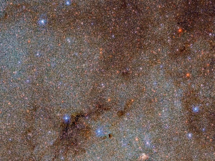 This image, which is brimming with stars and dark dust clouds, is a small extract — a mere pinprick — of the full Dark Energy Camera Plane Survey (DECaPS2) of the Milky Way. The new dataset contains a staggering 3.32 billion celestial objects — arguably the largest such catalog so far. The data for this unprecedented survey were taken with the US Department of Energy-fabricated Dark Energy Camera at the NSF’s Cerro Tololo Inter-American Observatory in Chile, a Program of NOIRLab.