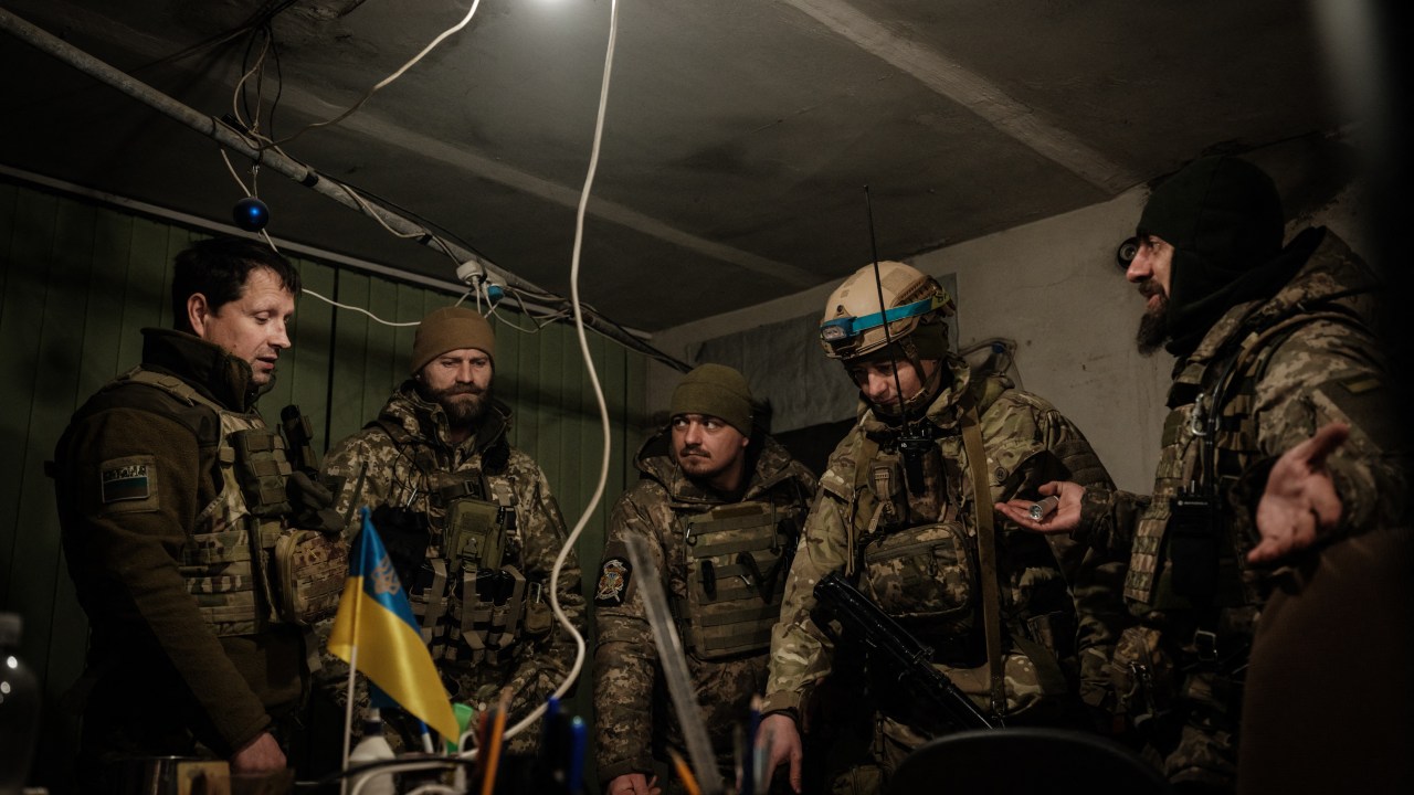 Ukrainian servicemen of the State Border Guard Service work in the operations room in Bakhmut on February 9, 2023, amid the Russian invasion of Ukraine. (Photo by YASUYOSHI CHIBA / AFP)
