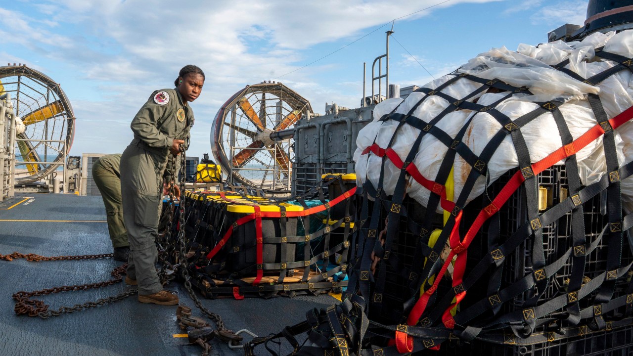 In this handout photo provided by the US Navy on February 13, 2023, sailors assigned to Assault Craft Unit 4 prepare material recovered in the Atlantic Ocean from a high-altitude balloon for transport to federal agents at Joint Expeditionary Base Little Creek in Virginia Beach, Virginia, on February 10, 2023. - At the direction of the President of the United States and with the full support of the Government of Canada, US fighter aircraft under US Northern Command authority engaged and brought down a high-altitude balloon within sovereign US airspace and over US territorial waters, on February 4, 2023. Active duty, reserve, National Guard, and civilian personnel planned and executed the operation, and partners from the US Coast Guard, Federal Aviation Administration, Federal Bureau of Investigation, and Naval Criminal Investigative Service (NCIS) ensured public safety throughout the operation and recovery efforts. (Photo by Ryan Seelbach / US NAVY / AFP) / RESTRICTED TO EDITORIAL USE - MANDATORY CREDIT "AFP PHOTO / Ryan Seelbach / US Navy " - NO MARKETING - NO ADVERTISING CAMPAIGNS - DISTRIBUTED AS A SERVICE TO CLIENTS