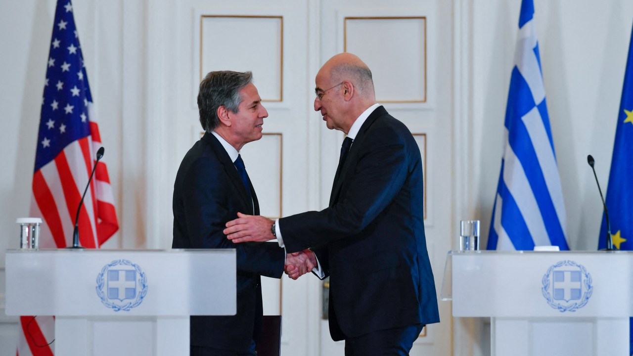 Greeces Foreign Affairs Minister Nikos Dendias (R) and US Secretary of State Antony Blinken, (L), shake hands during a press conference in Athens, on February 21, 2023. - Antony Blinken is on a two-day trip in Athens, following a trip to Turkey, for discussions on US-Greece Strategic Dialogue. (Photo by Michael Varaklas / POOL / AFP)