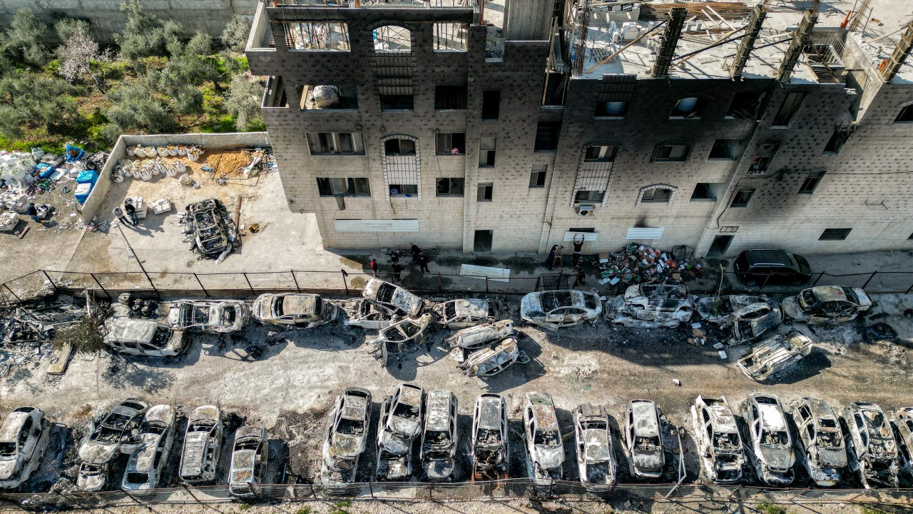 This picture taken on February 27, 2023 shows an aerial view of a scrapyard where cars were torched overnight, in the Palestinian town of Huwara near Nablus in the occupied West Bank. - Two Israelis living in the Har Bracha settlement near Nablus were killed on February 26 in a "Palestinian terror attack", officials said, sparking violence in which a Palestinian man was killed, while settlers torched homes in revenge. (Photo by RONALDO SCHEMIDT / AFP)