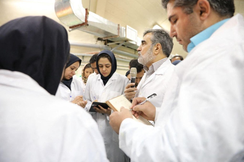 (FILES) This file handout picture released by Iran's Atomic Energy Organisation on November 9, 2019, shows then spokesman for the organisation Behrouz Kamalvandi (2nd-R) speaking with journalists at the Fordo (Forwdow) Uranium Conversion Facility in Qom, about 130 kilometres south of the capital Tehran. - The International Atomic Energy Agency (IAEA) confirmed on March 1, 2023 that it had detected particles of uranium enriched to 83.7 percent in Iran, just shy of the 90 percent needed to produce an atomic bomb, according to a report seen by AFP. (Photo by HO / Atomic Energy Organization of Iran / AFP) / RESTRICTED TO EDITORIAL USE - MANDATORY CREDIT "AFP PHOTO / Atomic Energy Organisation of Iran" - NO MARKETING NO ADVERTISING CAMPAIGNS - DISTRIBUTED AS A SERVICE TO CLIENTS