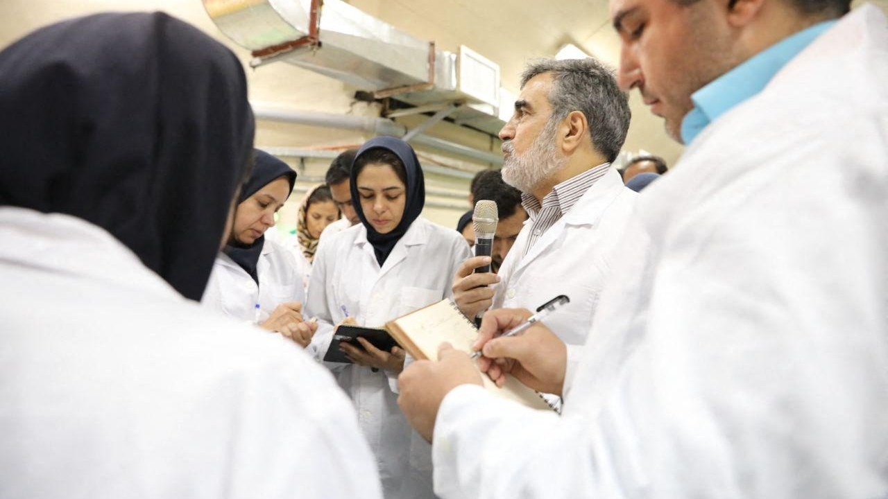 (FILES) This file handout picture released by Iran's Atomic Energy Organisation on November 9, 2019, shows then spokesman for the organisation Behrouz Kamalvandi (2nd-R) speaking with journalists at the Fordo (Forwdow) Uranium Conversion Facility in Qom, about 130 kilometres south of the capital Tehran. - The International Atomic Energy Agency (IAEA) confirmed on March 1, 2023 that it had detected particles of uranium enriched to 83.7 percent in Iran, just shy of the 90 percent needed to produce an atomic bomb, according to a report seen by AFP. (Photo by HO / Atomic Energy Organization of Iran / AFP) / RESTRICTED TO EDITORIAL USE - MANDATORY CREDIT "AFP PHOTO / Atomic Energy Organisation of Iran" - NO MARKETING NO ADVERTISING CAMPAIGNS - DISTRIBUTED AS A SERVICE TO CLIENTS