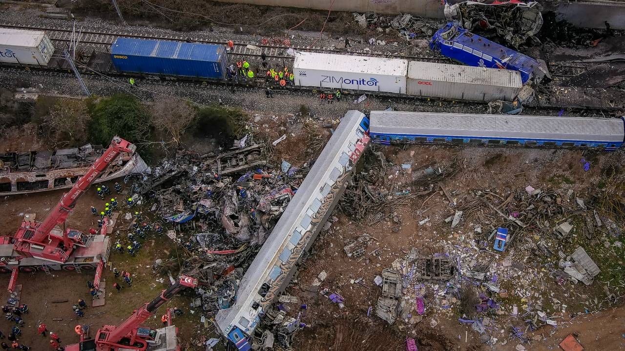 This aerial drone photograph taken on March 1, 2023, shows emergency crews searching wreckage after a train accident in the Tempi Valley near Larissa, Greece. - At least 32 people were killed and another 85 injured after a collision between two trains caused a derailment near the Greek city of Larissa late at night on February 28, 2023, authorities said. A fire services spokesman confirmed that three carriages skipped the tracks just before midnight after the trains -- one for freight and the other carrying 350 passengers - collided about halfway along the route between Athens and Thessaloniki. (Photo by Vasilis VERVERIDIS / Eurokinissi/motionteam / AFP)