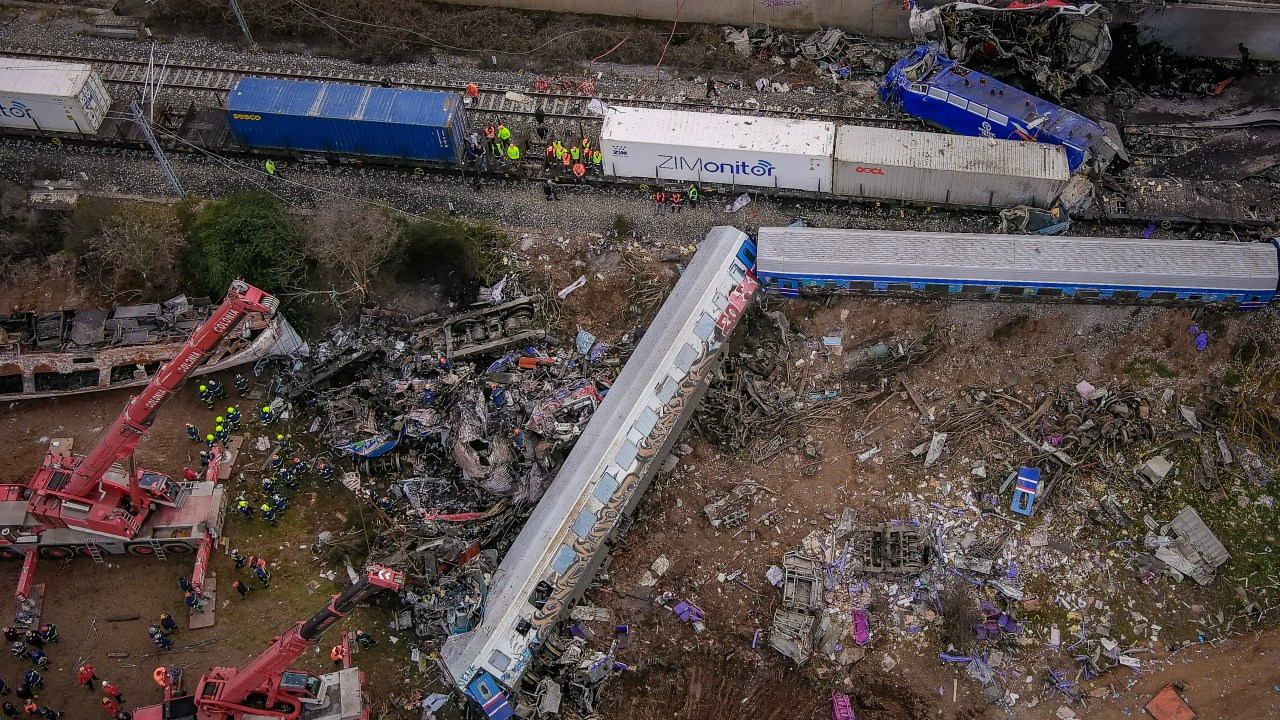 This aerial drone photograph taken on March 1, 2023, shows emergency crews searching wreckage after a train accident in the Tempi Valley near Larissa, Greece. - At least 32 people were killed and another 85 injured after a collision between two trains caused a derailment near the Greek city of Larissa late at night on February 28, 2023, authorities said. A fire services spokesman confirmed that three carriages skipped the tracks just before midnight after the trains -- one for freight and the other carrying 350 passengers - collided about halfway along the route between Athens and Thessaloniki. (Photo by Vasilis VERVERIDIS / Eurokinissi/motionteam / AFP)