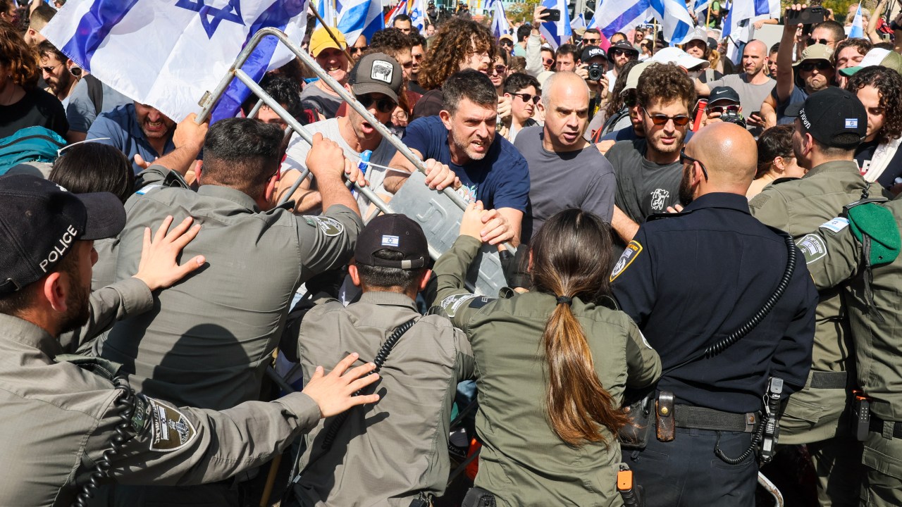 Protesters scuffle with members of Israeli security forces during a demonstration against the government's controversial justice reform bill in Tel Aviv on March 1, 2023. (Photo by JACK GUEZ / AFP)