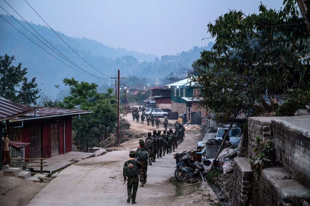 In this photo taken on March 9, 2023 members of ethnic rebel group Ta'ang National Liberation Army (TNLA) patrol near Namhsan Township in Myanmar's northern Shan State. (Photo by AFP)