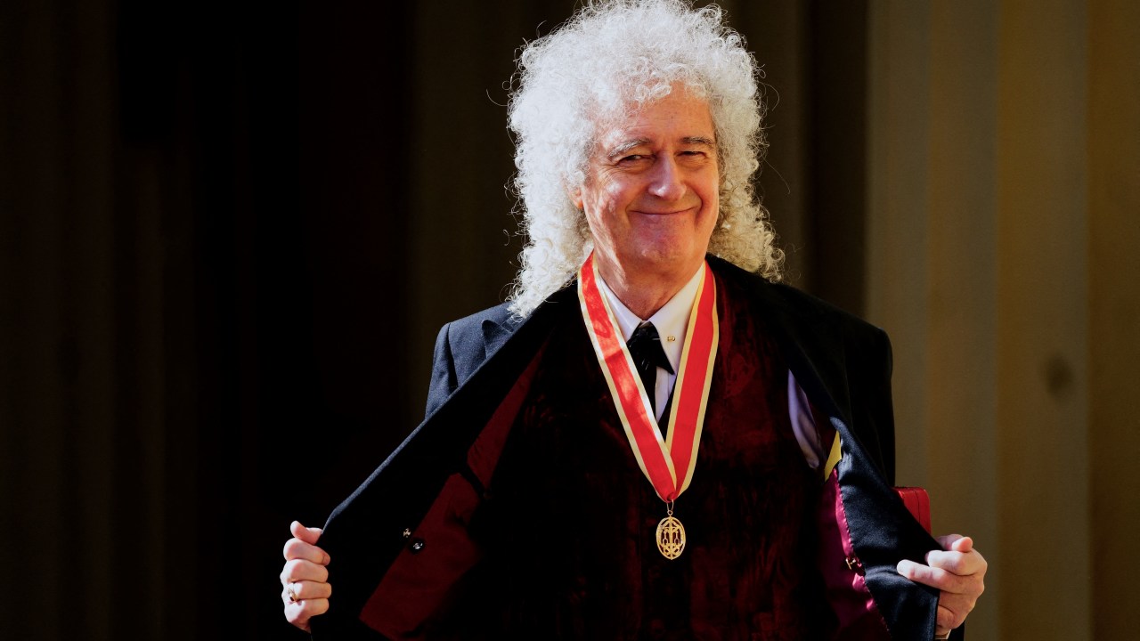 British musician Brian May poses with his medal after being appointed as a Knight Bachelor (Knighthood) during an investiture ceremony at Buckingham Palace, in London, on March 14, 2023. (Photo by Victoria Jones / POOL / AFP)