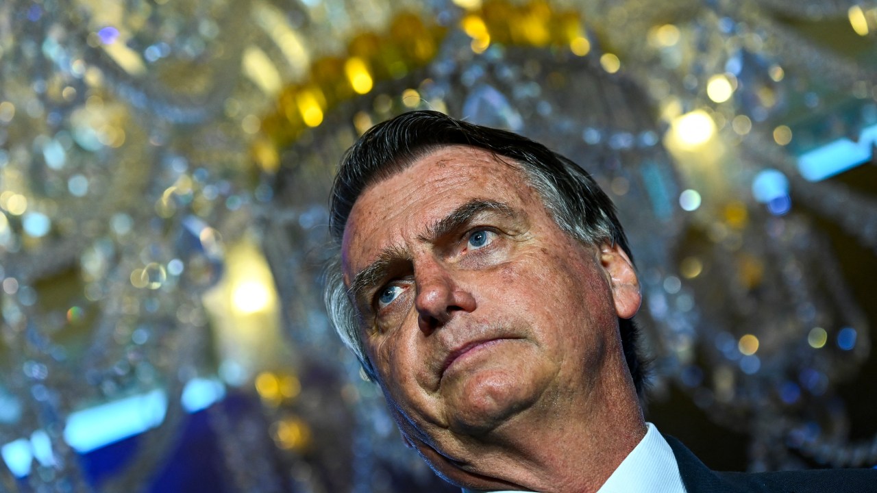 (FILES) In this file photo taken on February 3, 2023, former Brazilian President Jair Bolsonaro speaks during a "Power of the People Rally" at Trump National Doral resort in Miami, Florida. - Bolsonaro is in hot water over allegations he tried to illegally import millions of dollars' worth of jewellery given to him and his wife by Saudi Arabia in October 2021. The scandal has triggered multiple investigations, potentially complicating life for Bolsonaro -- who is expected to return soon to Brazil from the United States, where the far-right ex-army captain has been living since just before his leftist successor, Luiz Inacio Lula da Silva, took office on January 1. Brazilian media reported on March 13, 2023, that Bolsonaro had agreed to hand a second set of jewels over to the authorities pending investigation. (Photo by CHANDAN KHANNA / AFP)