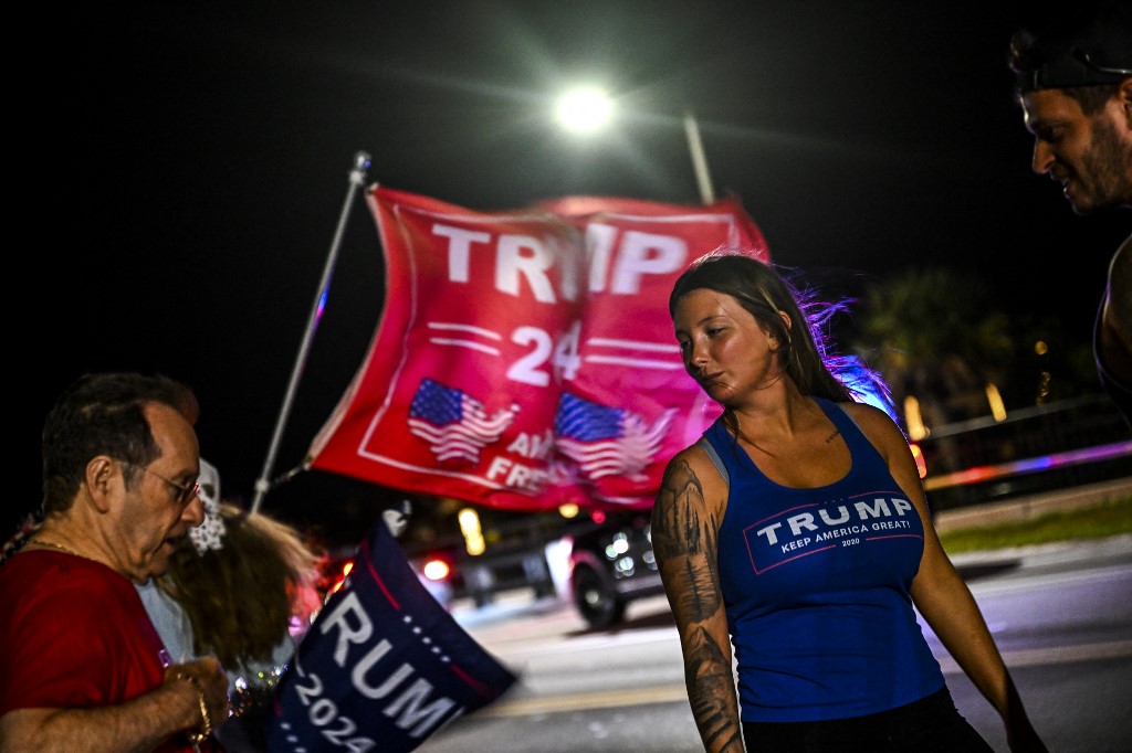 Supporters of former US President Donald Trump protest near the Mar-a-Lago Club in Palm Beach, Florida, on March 30, 2023. - A New York grand jury has voted to indict former US president Donald Trump over hush money payments made to porn star Stormy Daniels ahead of the 2016 election, multiple US media reported on March 30, 2023. (Photo by CHANDAN KHANNA / AFP)