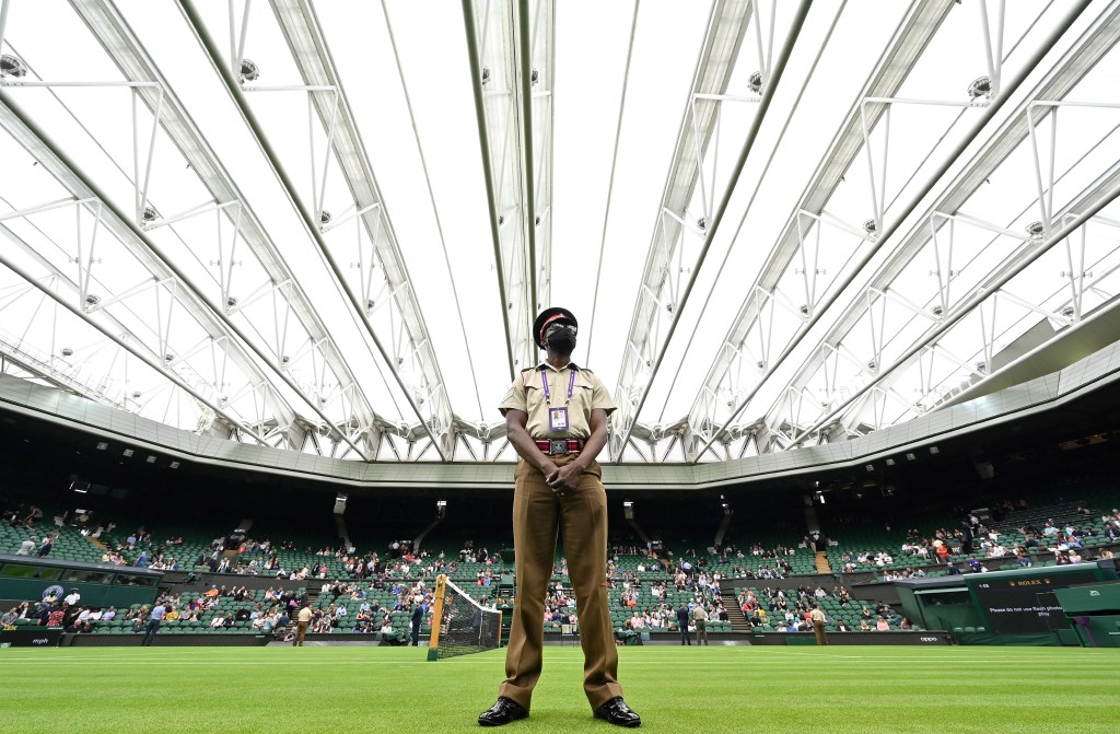 (FILES) In this file photo taken on June 28, 2021 a member of Britain's armed forces stands on duty ahead of a men's singles first round match, under the closed roof on Centre Court, on the first day of the 2021 Wimbledon Championships at The All England Tennis Club in Wimbledon, south-west London. - Russian and Belarusian players will be allowed to compete at Wimbledon this year after organisers announced on Friday, Mrch 31, they were lifting a ban imposed in 2022. (Photo by Glyn KIRK / AFP) / RESTRICTED TO EDITORIAL USE