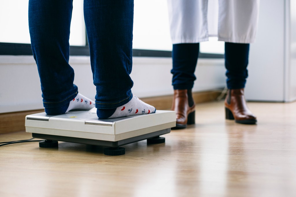 Close-up ofwoman on scales in medical practice