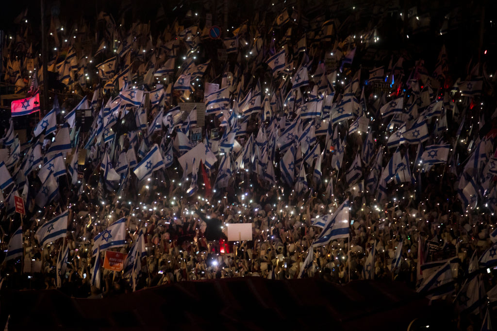 TEL AVIV, ISRAEL - MARCH 11: Tens of thousands of Israelis attend a massive protest against the government's judicial overhaul plan on March 11, 2023 in Tel Aviv, Israel. The Netanyahu government is pushing ahead with proposed overhaul of the judiciary that would limit the Israeli Supreme Court's ability to review and strike down laws that it deems unconstitutional. Critics say the changes will undermine judicial independence and threaten Israel's democracy. (Photo by Amir Levy/Getty Images)