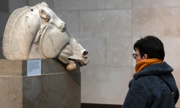 A visitor views one of the Parthenon marbles, also known as the Elgin marbles, at the British Museum in London.