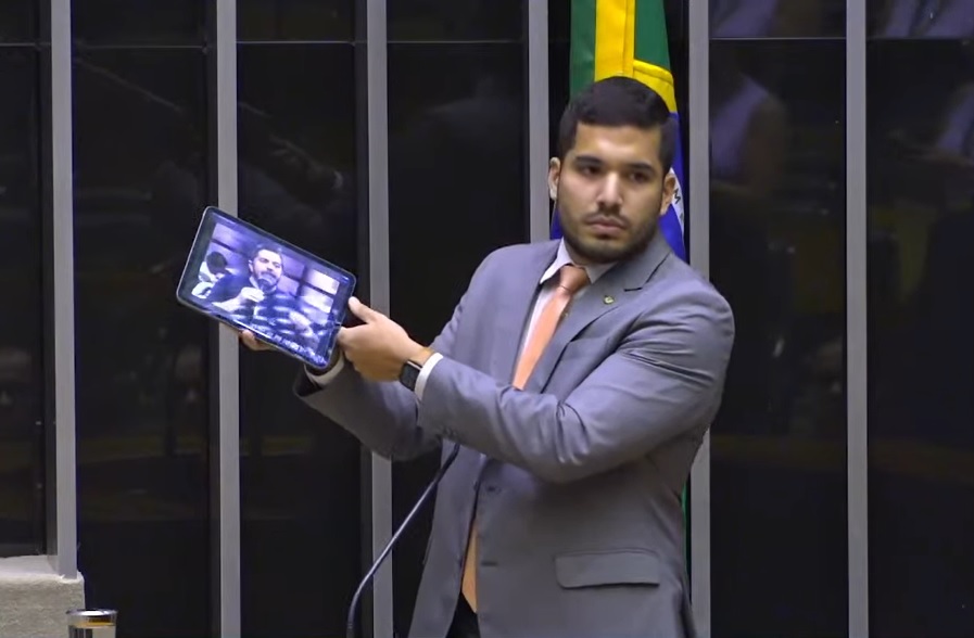 O deputado federal André Fernandes (PL-CE) exibe um vídeo de uma fala antiga do presidente Lula na tribuna do plenário da Câmara, nesta quarta-feira