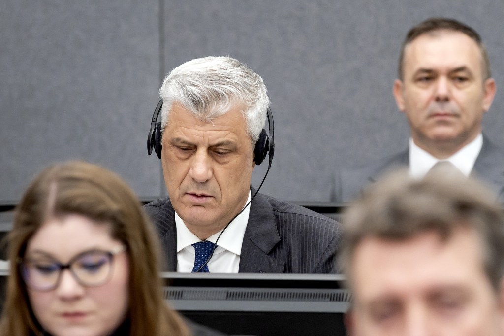 Former Kosovo president Hashim Thaci (L) sits in court, near former KLA figure Rexhep Selimi (rear), as he appears on charges of war crimes before the Kosovo Tribunal in The Hague on April 3, 2023. - Former Kosovo president Hashim Thaci goes on trial at a Hague war crimes tribunal on April 3, accused of a bloody campaign of murder and torture in the 1998-1999 independence war with Serbia. The one-time guerrilla hero, who denies the charges, allegedly targeted perceived enemies of the ethnic Albanian Kosovo Liberation Army (KLA), including Serbs and Roma, as the rebels sought to seize power. (Photo by Koen van Weel / ANP / AFP) / Netherlands OUT