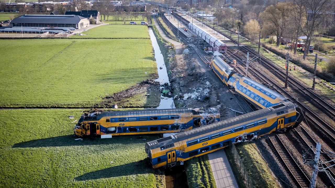 This aerial view shows a derailed night train in Voorschoten on April 4, 2023. - At least one person died and 30 were injured early on April 4 when a high-speed passenger train slammed into heavy construction equipment and derailed near The Hague, Dutch emergency services said. (Photo by Remko de Waal / ANP / AFP) / Netherlands OUT