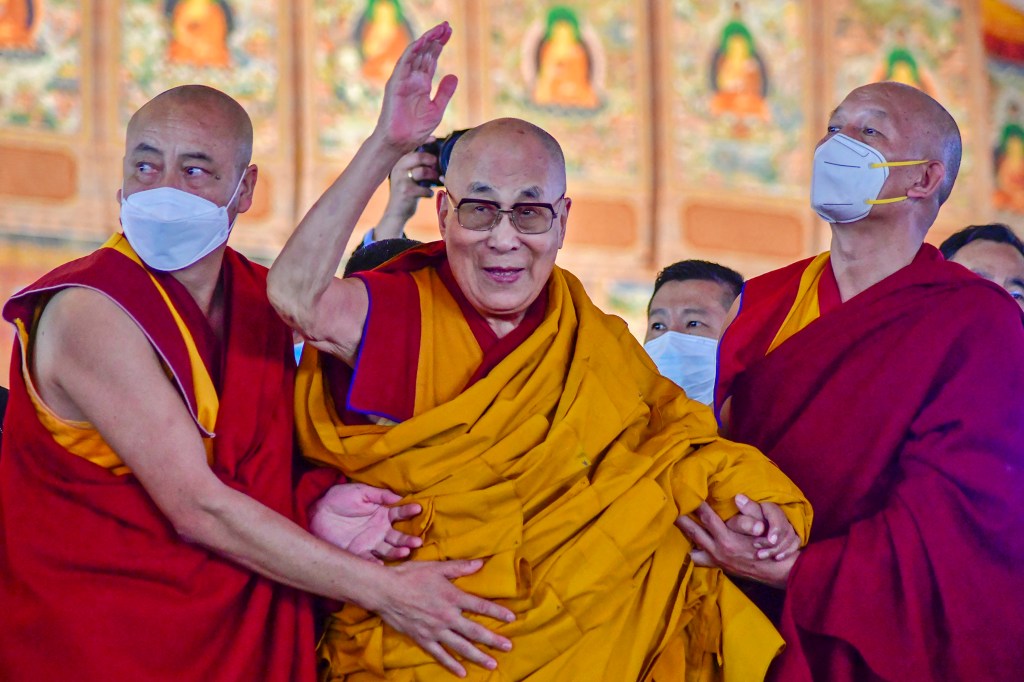 (FILES) In this file photo taken on December 29, 2022, Tibetan spiritual leader Dalai Lama waves during his first day of teaching session at the Kalachakra Ground in Bodhgaya. - The Tibetan spiritual leader the Dalai Lama apologised on April 10, 2023 after a video which showed him asking a boy to suck his tongue triggered a backlash on social media. (Photo by Sanjay KUMAR / AFP)