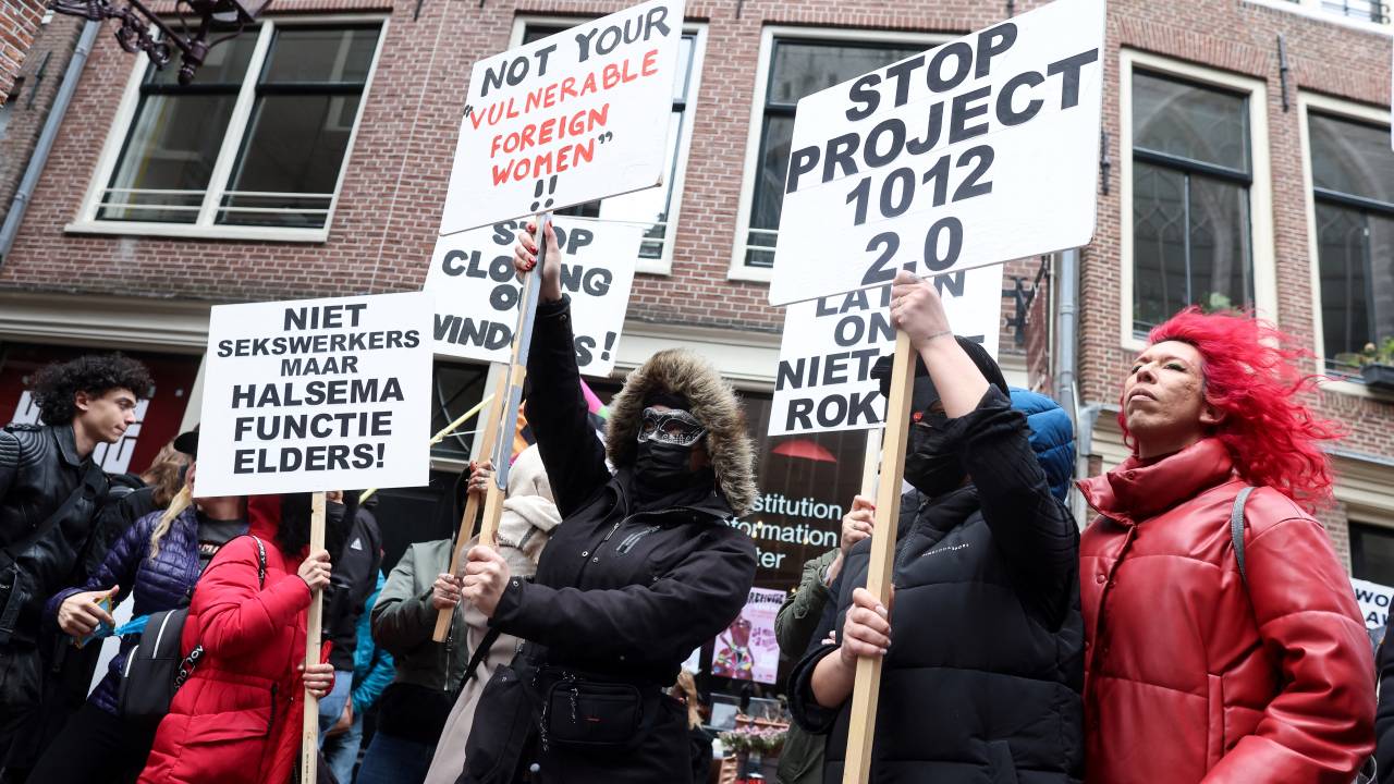 (FILES) In this file photo taken on March 30, 2023 Sex workers and sympathisers take part in a demonstration to protest plans to shutter the city's historic red light district, to be moved to a new erotic centre, in Amsterdam on March 30, 2023. - Sex workers and residents oppose an "erotic centre" project as Amsterdam wants to move legal prostitution outside the city centre's famed red light district over complaints from residents over crime and visitors' behaviour. (Photo by Kenzo TRIBOUILLARD / AFP)