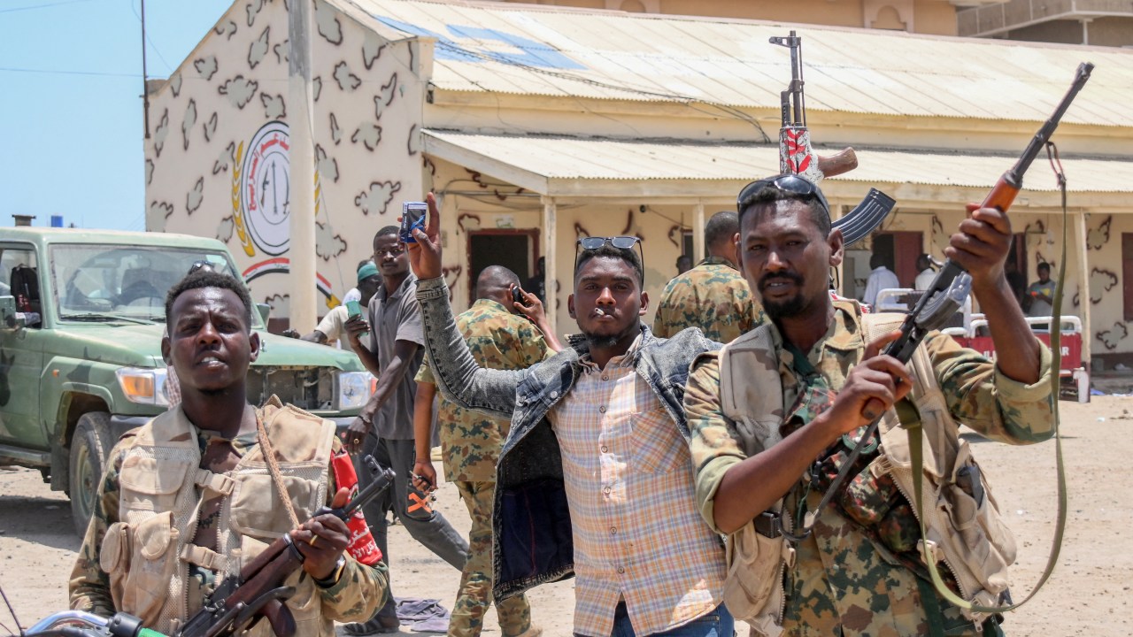 This picture taken on April 16, 2023, shows Sudanese army soldiers, loyal to army chief Abdel Fattah al-Burhan, posing for a picture at the Rapid Support Forces (RSF) base in the Red Sea city of Port Sudan. - Battling fighters in Sudan said they had agreed to an hours-long humanitarian pause, including to evacuate wounded, on the second day of raging urban battles that killed more than 50 civilians including three UN staff and sparking international outcry. (Photo by AFP)