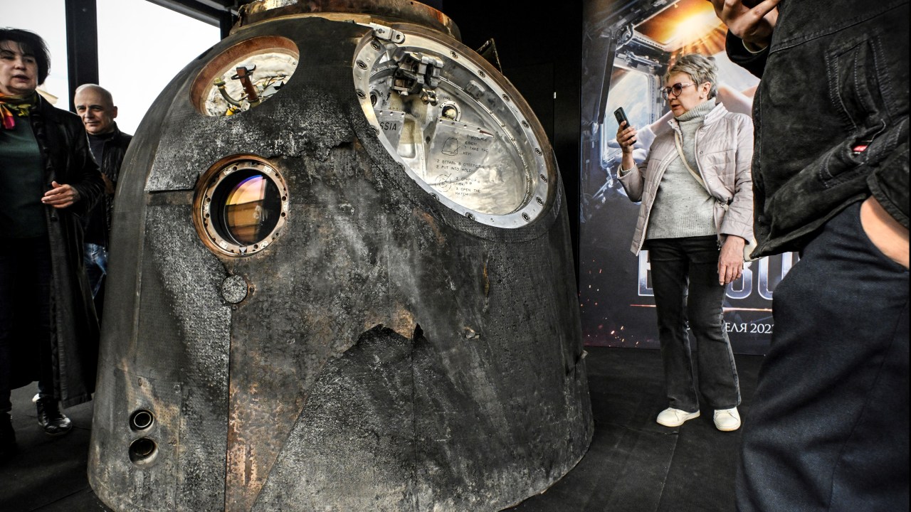 Visitors inspect the Russian Soyuz MS-18 space capsule which brought back to the Earth on October 17, 2021 Russian actress Yulia Peresild, in Moscow on April 18, 2023. - The Russian actress and film director spent 12 days on the International Space Station (ISS) shooting scenes for the first movie made in Space. The first night of "Challenge" is scheduled on April 20, 2023. (Photo by Alexander NEMENOV / AFP)