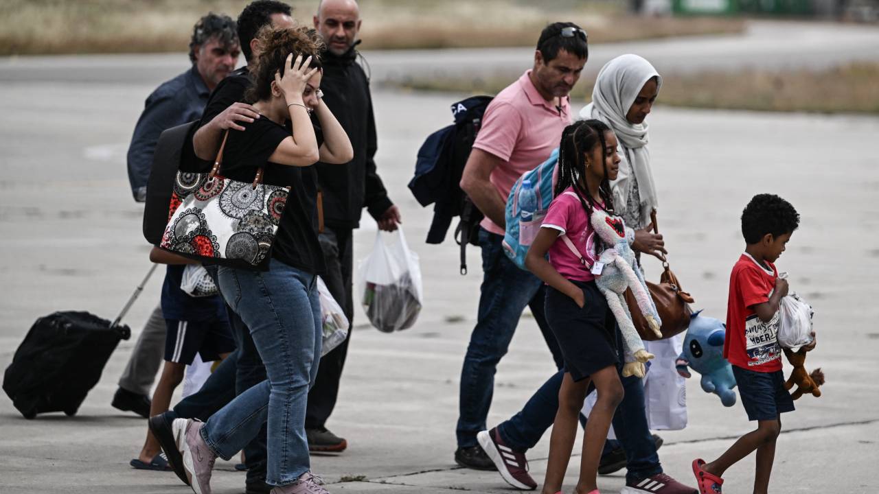 Greek nationals from Sudan arrive with a military C-27 plane at the military airport of Elefsina, south of Athens, on April 25, 2023. - Greeces foreign ministry announced the evacuation of another 7 Greeks and family members to Aqaba as a growing number of countries continue to evacuate foreign nationals and diplomats following almost 10 days of urban combat in Khartoum. (Photo by Aris Messinis / AFP)