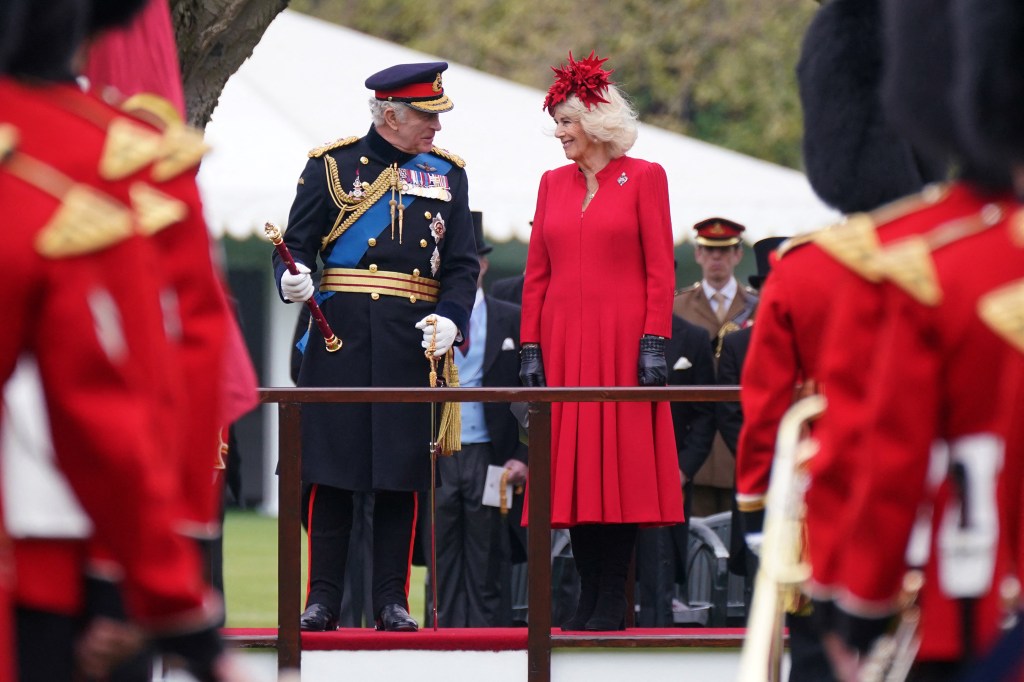 Britain's King Charles III (L) and Britain's Camilla, Queen Consort (R) attend a ceremony to present the new standards and colours to the Royal Navy, the Life Guards of the Household Cavalry Mounted Regiment, The Kings Company of the Grenadier Guards and The Kings Colour Squadron of the Royal Air Force at Buckingham Palace, in London, on April 27, 2023. (Photo by Yui Mok / POOL / AFP)