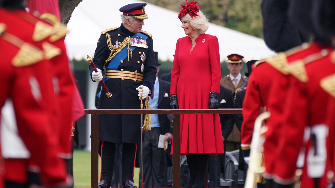 Britain's King Charles III (L) and Britain's Camilla, Queen Consort (R) attend a ceremony to present the new standards and colours to the Royal Navy, the Life Guards of the Household Cavalry Mounted Regiment, The Kings Company of the Grenadier Guards and The Kings Colour Squadron of the Royal Air Force at Buckingham Palace, in London, on April 27, 2023. (Photo by Yui Mok / POOL / AFP)