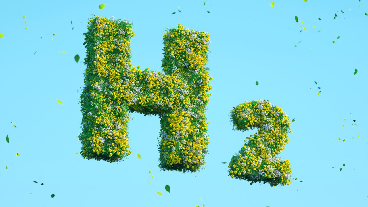Digital generated image of H2 hydrogen icon made out of grass and flowers on blue background.