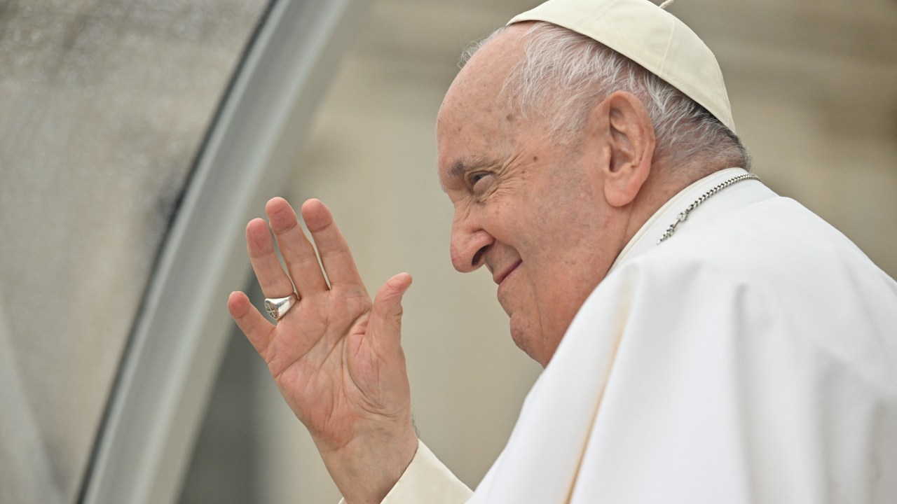 Pope Francis waves as he leaves in the popemobile car following the weekly general audience on May 10, 2023 at St. Peter's square in The Vatican. (Photo by Filippo MONTEFORTE / AFP)