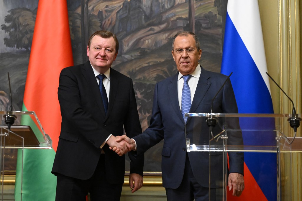 Russian Foreign Minister Sergei Lavrov and his Belarusian counterpart Sergei Aleinik shake hands during a joint press conference following their talks in Moscow on May 17, 2023. (Photo by NATALIA KOLESNIKOVA / POOL / AFP)