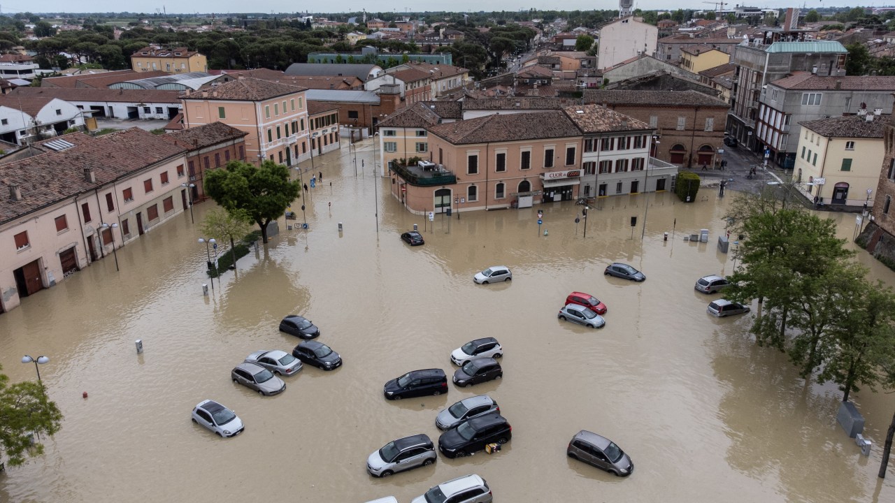 This aerial photograph shows flooded streets in the town of Lugo, near Ravenna, on May 18, 2023, after heavy rains caused flooding across Italy's northern Emilia Romagna region. Rescue workers searched on May 18, 2023 for people still trapped by floodwaters in northeast Italy as more residents were evacuated after downpours which killed nine people and devastated homes and farms. (Photo by Federico SCOPPA / AFP)