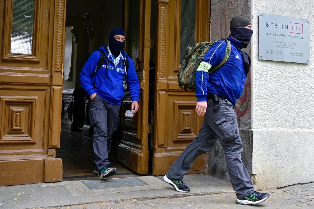 Police officers leave after the search of a building in Berlin's Kreuzberg distrct in connection with the "Letzte Generation" (Last Generation) group on May 24, 2023. German police on May 24, 2023 carried out raids across seven states targeting climate activists of the "Letzte Generation" (Last Generation) group, which has sparked controversy with street blockades involving protesters glueing themselves to the asphalt. (Photo by John MACDOUGALL / AFP) / ALTERNATIVE CROP