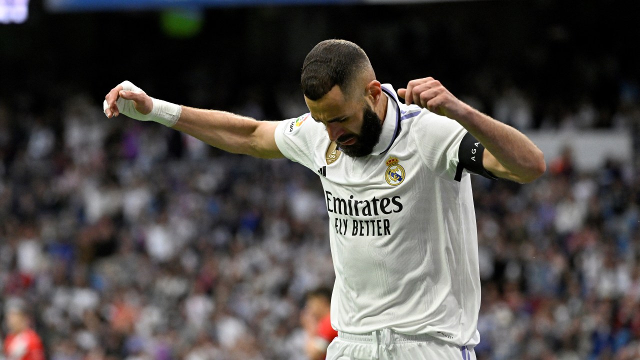 Real Madrid's French forward Karim Benzema celebrates scoring his team's first goal during the Spanish league football match between Real Madrid CF and Rayo Vallecano de Madrid at the Santiago Bernabeu stadium in Madrid on May 24, 2023. (Photo by JAVIER SORIANO / AFP)