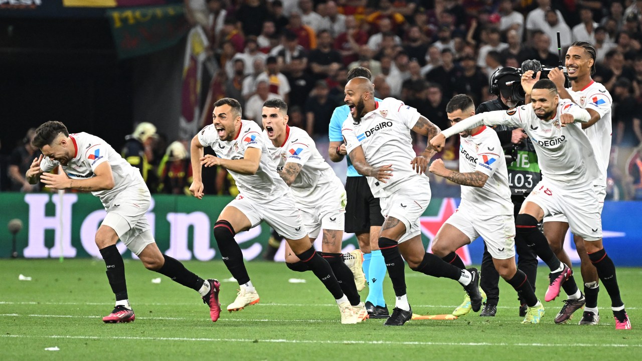 Sevilla's players celebrate after winning the penalty shootout of the UEFA Europa League final football match between Sevilla FC and AS Roma at the Puskas Arena in Budapest, Hungary on May 31, 2023. (Photo by Attila KISBENEDEK / AFP)