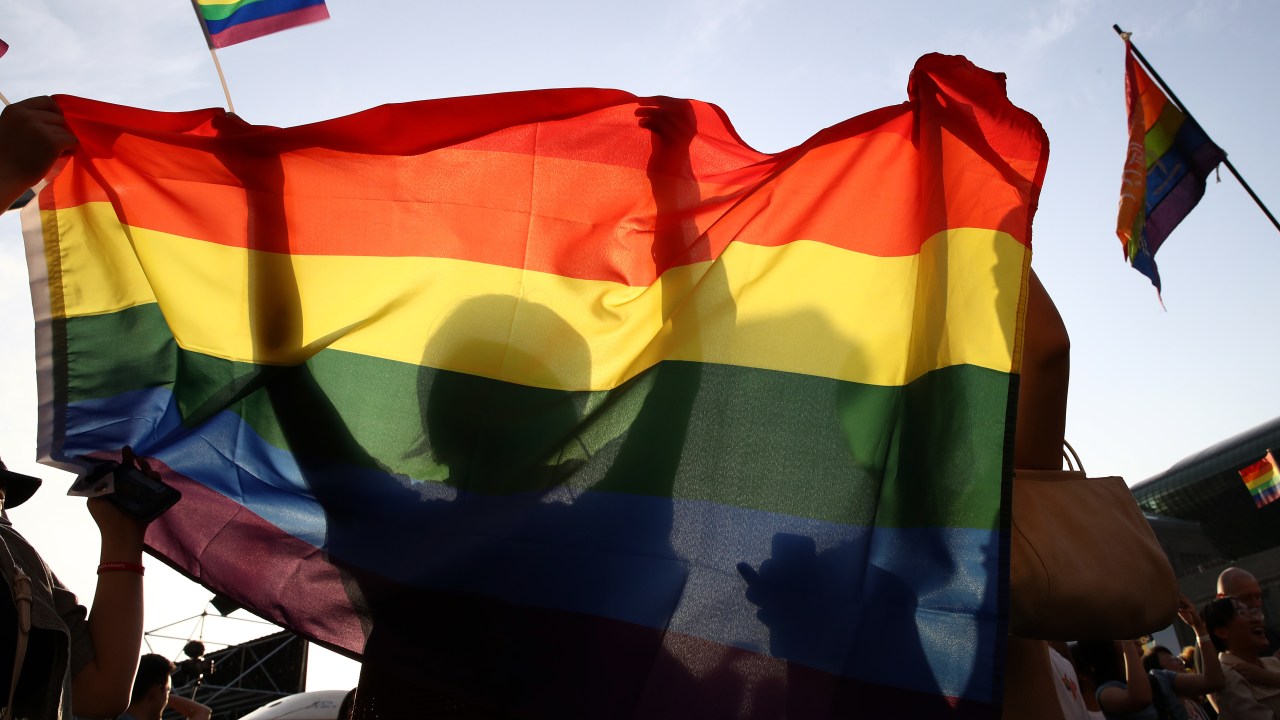 SEOUL, SOUTH KOREA - JUNE 01: People wave a rainbow pride flag during the Korea Queer Culture Festival 2019 in front of City hall on June 01, 2019 in Seoul, South Korea. The annual festival promoting the LGBT rights had occasionally been disrupted by anti-LGBT groups in the past, although homosexuality is not illegal in the country. (Photo by Chung Sung-Jun/Getty Images)
