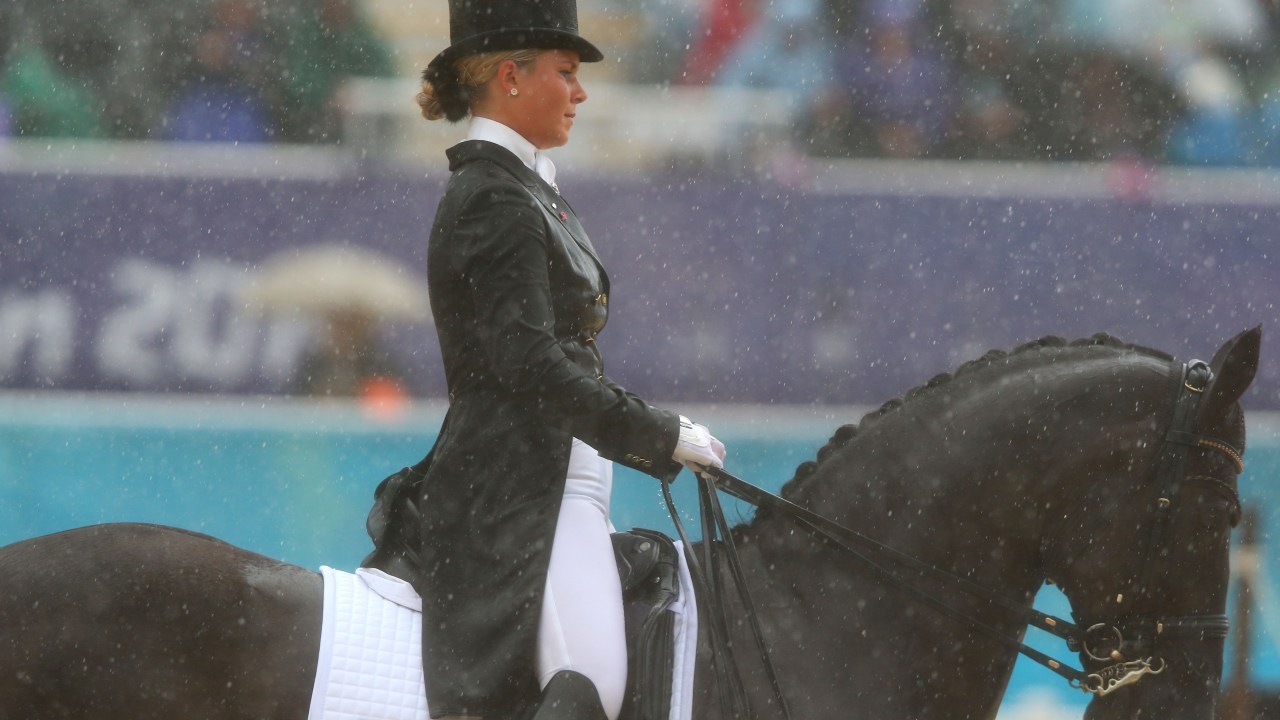 LONDON, ENGLAND - AUGUST 02: Anna Kasprzak of Denmark riding Donnperignon during a rain shower in the Dressage Grand Prix on Day 6 of the London 2012 Olympic Games at Greenwich Park on August 2, 2012 in London, England. (Photo by Alex Livesey/Getty Images)