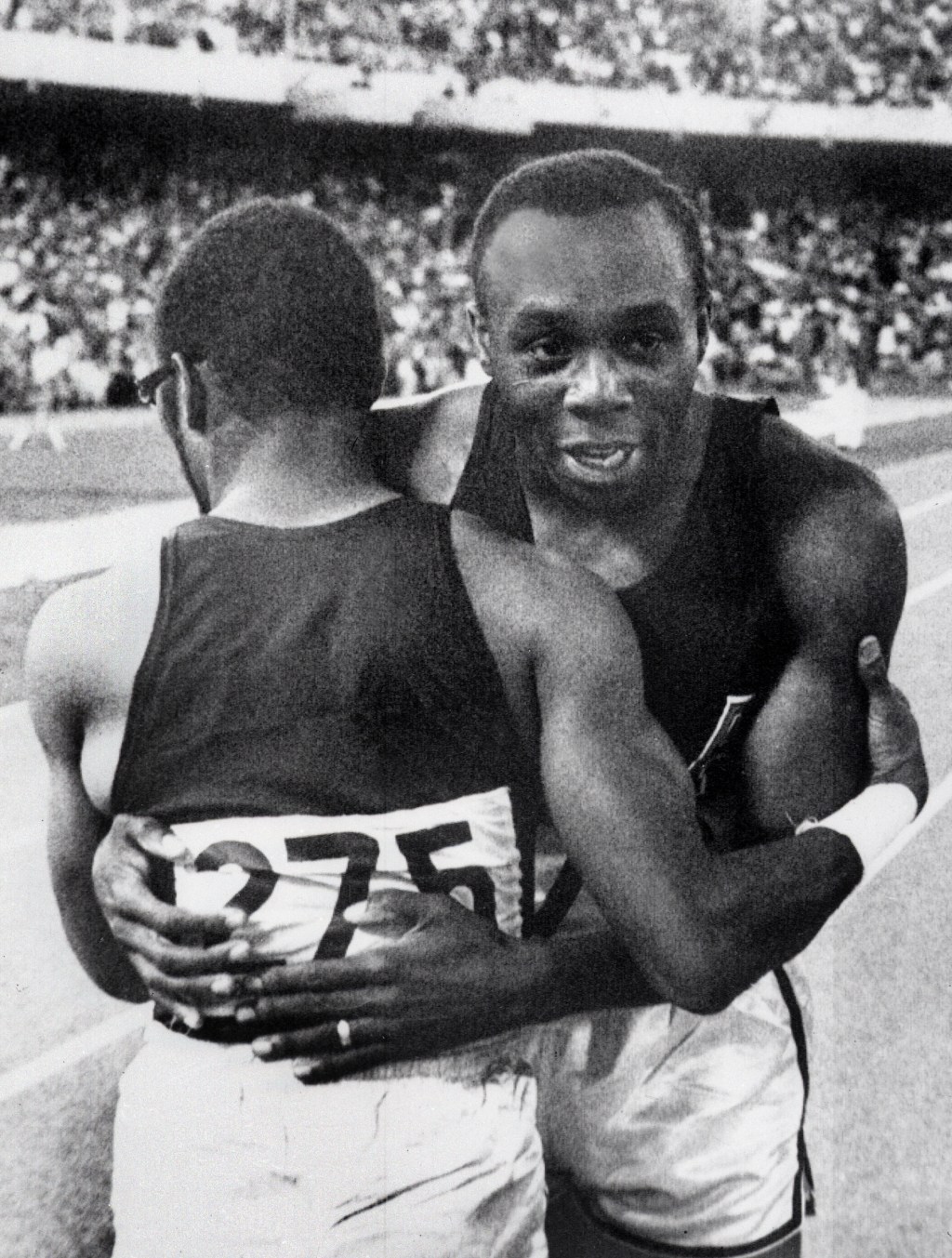 (FILES) American champion Jim Hines (R) is congratulated by his compatriot Charles Green upon his Olympics 100m victory, clocking a time of 9.9, on October 14, 1968 in Mexico City. Hins was the first man who ran the 100m under 10