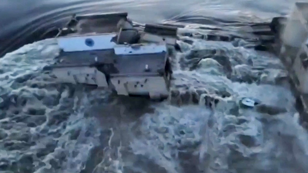This screen grab from a video posted on Ukraine's President Volodymyr Zelensky's Twitter account on June 6, 2023 shows an aerial view of the dam of the Kakhovka Hydroelectric Power Station after it was partially destroyed. A Russian-held dam in southern Ukraine was damaged on June 6, with Kyiv and Moscow accusing each other of blowing it up while locals were forced to flee rising waters. (Photo by various sources / AFP) / -----EDITORS NOTE --- RESTRICTED TO EDITORIAL USE - MANDATORY CREDIT "AFP PHOTO /Twitter / Account of Ukraine's President Volodymyr Zelensky @ZelneskyyUa " - NO MARKETING - NO ADVERTISING CAMPAIGNS - DISTRIBUTED AS A SERVICE TO CLIENTS