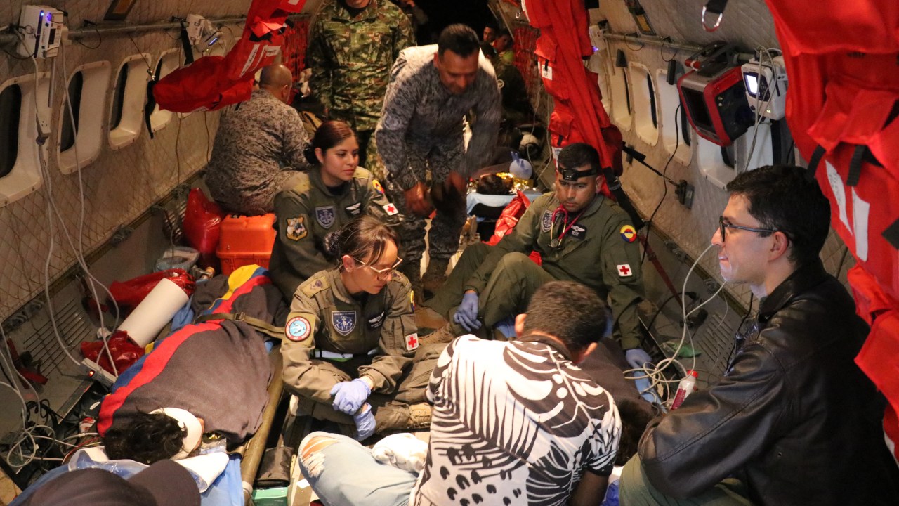 This handout picture taken on June 9, 2023 released by the Colombian Air Force shows members of the Colombian Army checking one of the four Indigenous children who were found alive after being lost for 40 days in the Colombian Amazon rainforest following a plane crash in San Jose del Guaviare during their transfer to Bogota. Exhausted but happy, four Indigenous children who had been missing for more than a month in the Colombian Amazon rainforest were reunited with their relatives Saturday, in a happy ending to a nerve-racking saga that gripped the nation. (Photo by Handout / Colombian Air Force / AFP) / RESTRICTED TO EDITORIAL USE - MANDATORY CREDIT "AFP PHOTO / COLOMBIAN AIR FORCE" - NO MARKETING NO ADVERTISING CAMPAIGNS - DISTRIBUTED AS A SERVICE TO CLIENTS