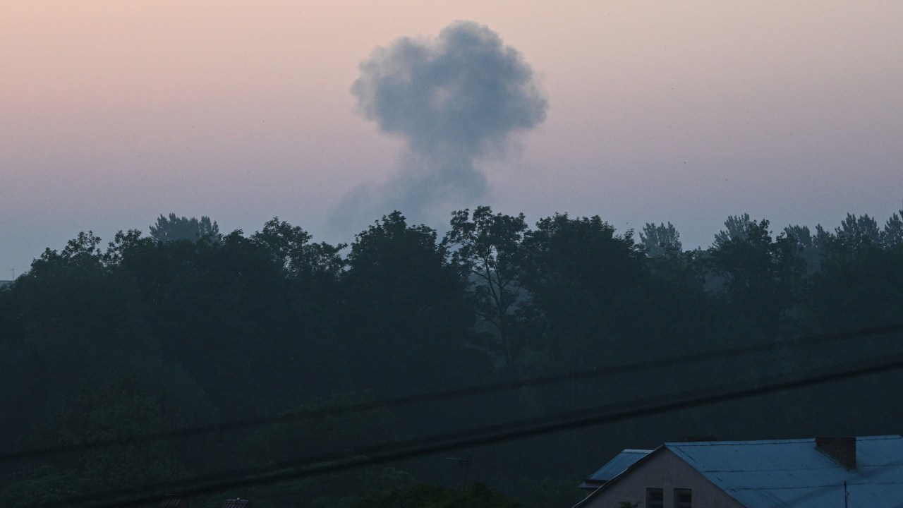 This picture shows a cloud of smoke after a night drone strike in the western Ukrainian city of Lviv on June 20, 2023, amid Russia's military invasion on Ukraine. Russian forces launched a major drone assault on Kyiv overnight as well as attacking other regions, Ukrainian officials said early on June 20, but there were no immediate reports of casualties. (Photo by YURIY DYACHYSHYN / AFP)