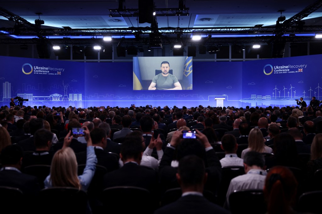 Ukraine's President Volodymyr Zelensky delivers a speech via videolink on the first day of the Ukraine Recovery Conference in London on June 21, 2023. Leaders and representatives from more than 60 countries are in London for a two-day conference to secure funding to help Ukraine recover from the ravages of war. (Photo by HENRY NICHOLLS / POOL / AFP)