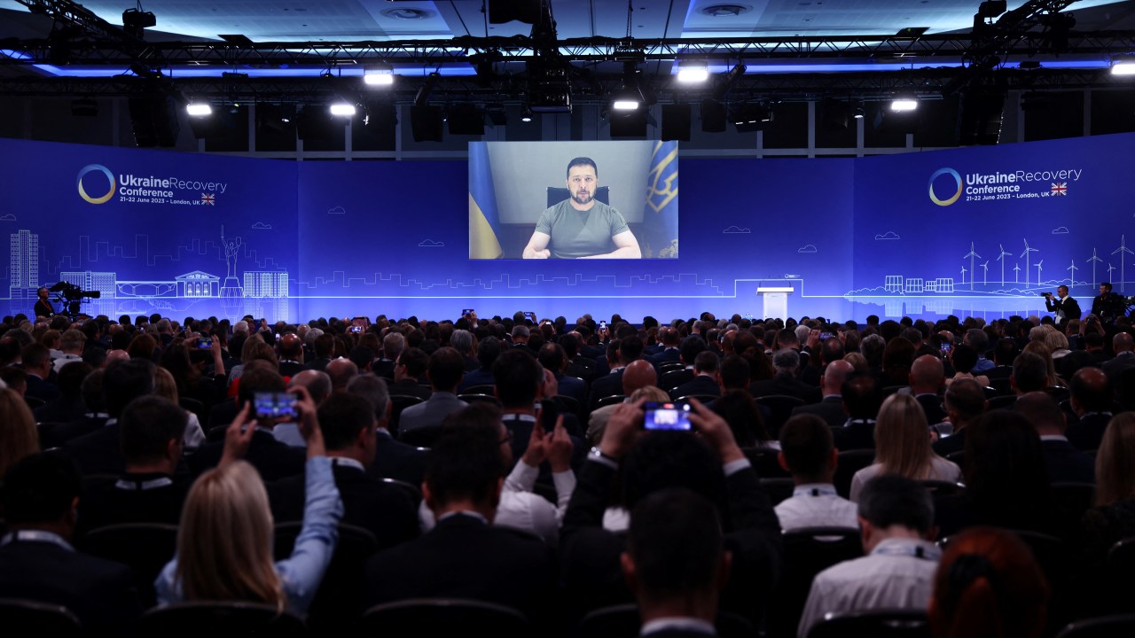 Ukraine's President Volodymyr Zelensky delivers a speech via videolink on the first day of the Ukraine Recovery Conference in London on June 21, 2023. Leaders and representatives from more than 60 countries are in London for a two-day conference to secure funding to help Ukraine recover from the ravages of war. (Photo by HENRY NICHOLLS / POOL / AFP)
